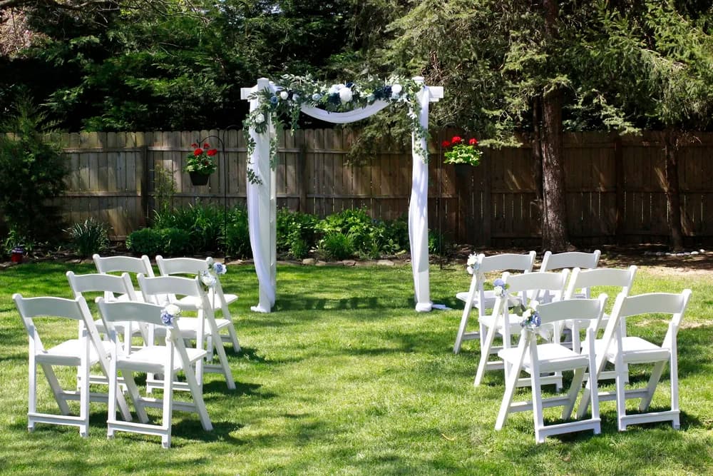 Traditional white arch outdoor wedding