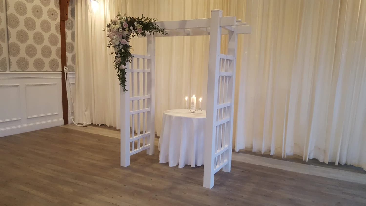 Traditional white arch styled for a wedding