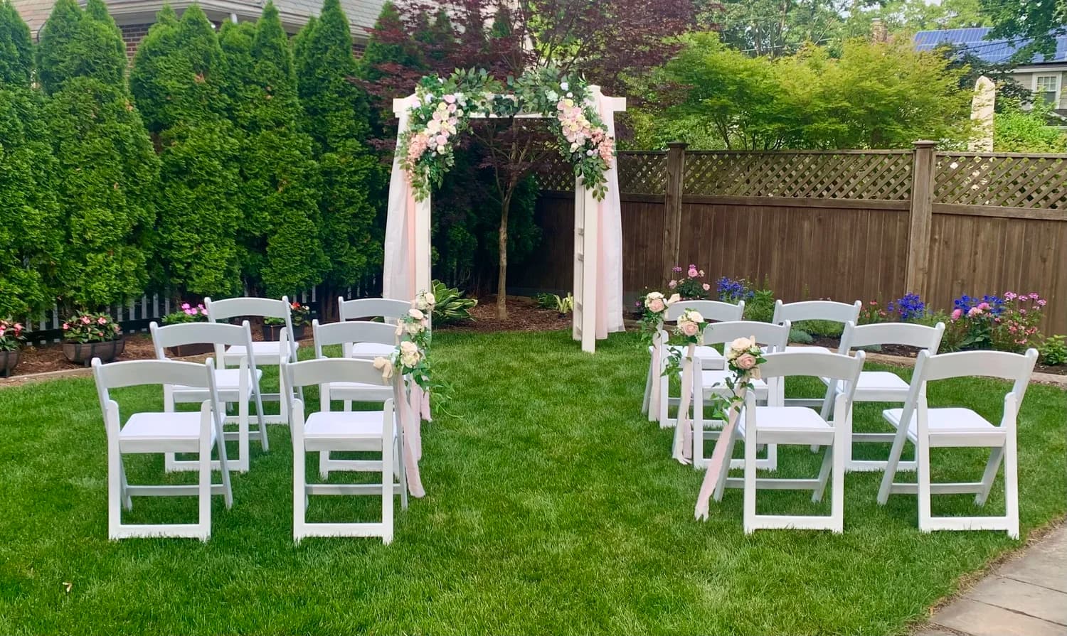 Traditional white arch at a garden ceremony
