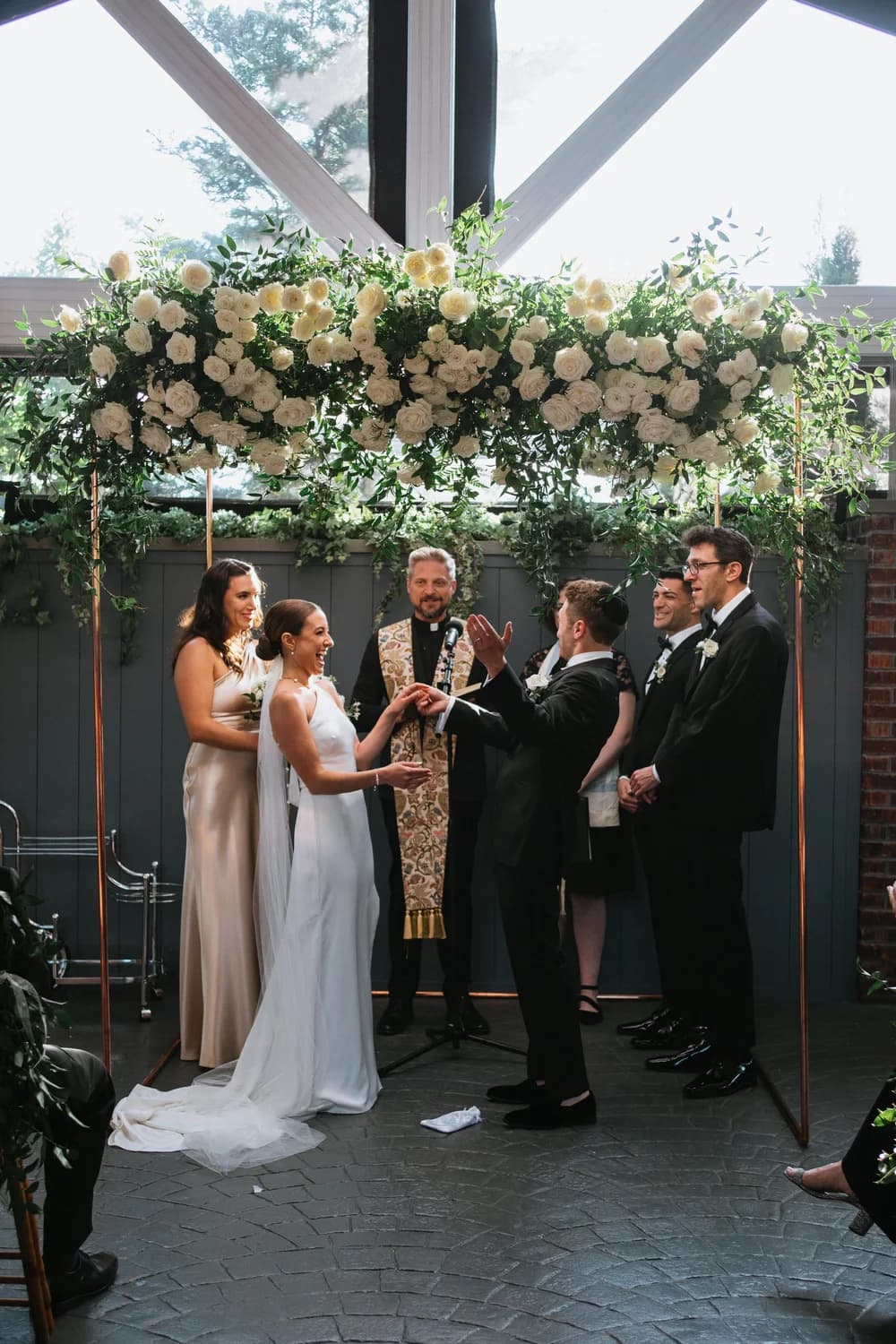 Copper canopy with white draping and florals