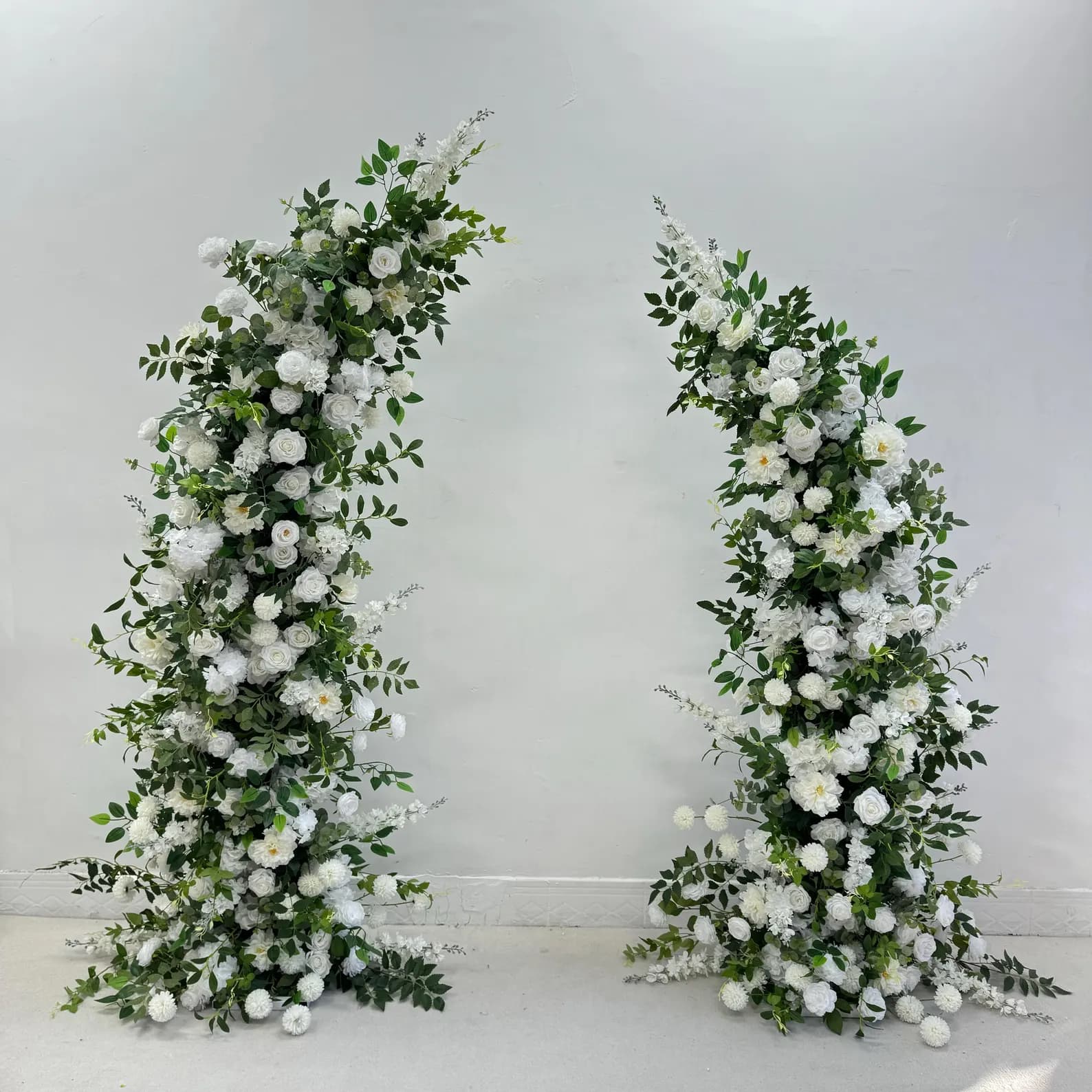 Two piece flower arch on white backdrop