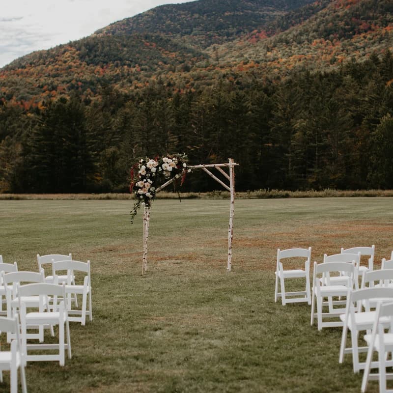 Traditional white wedding arch at a ceremony
