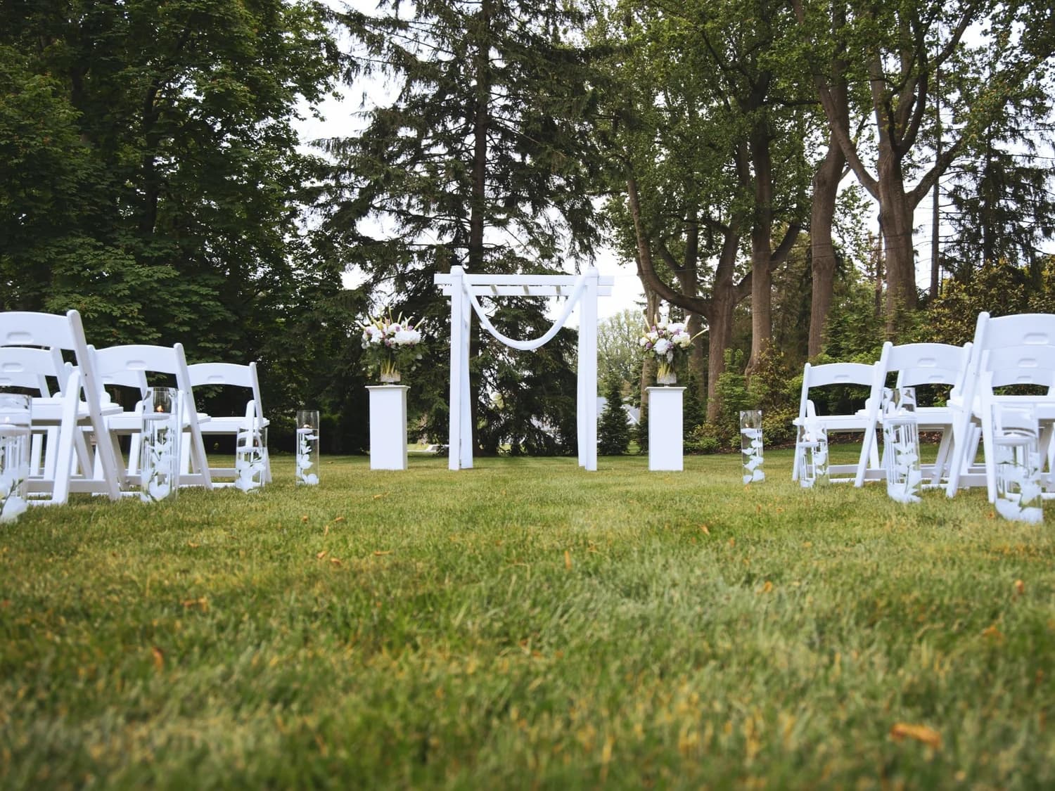 Traditional white wedding arch at a ceremony