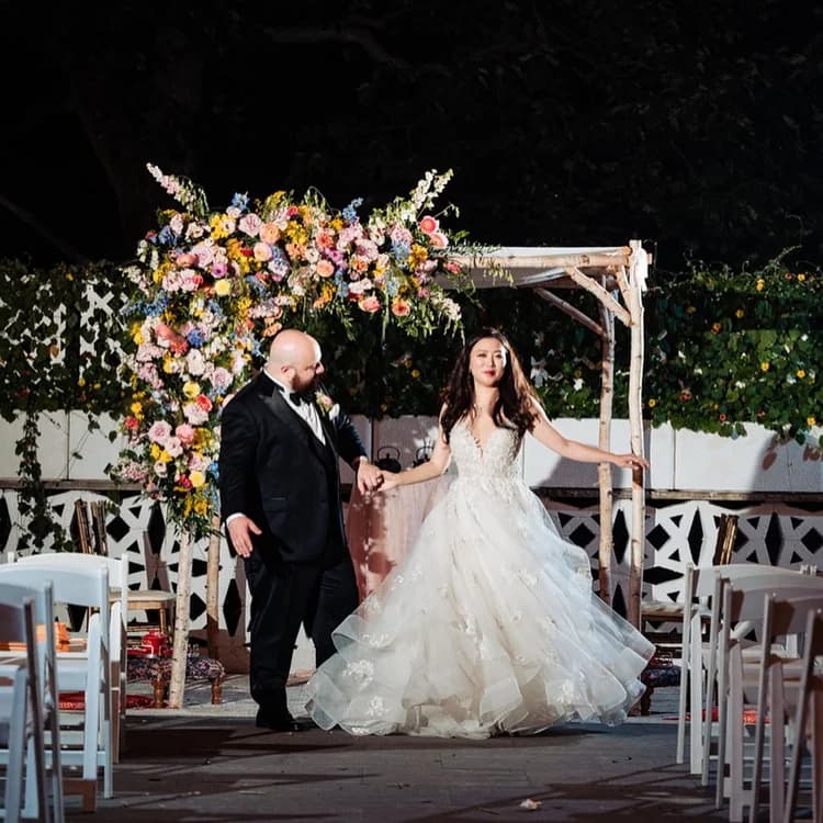White birch canopy with white fabric and florals