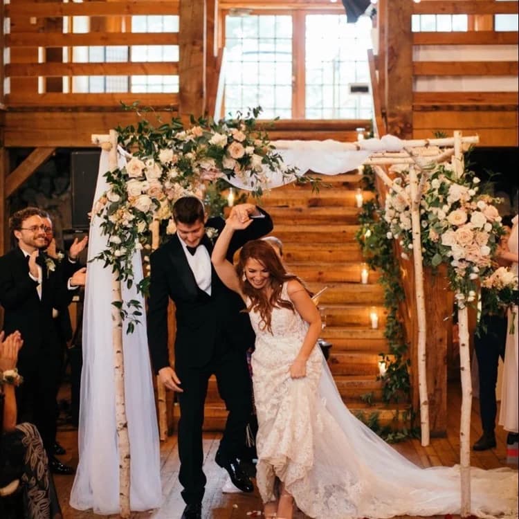 Couple under a white birch canopy